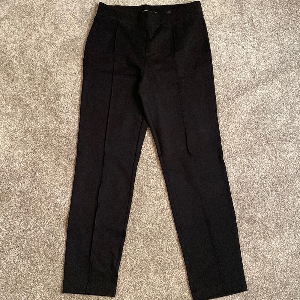Black leggings with stretchy waist band and seam that runs down the leg.